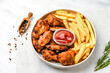 lunch fast food chicken wings with ketchup and potatoes fries	