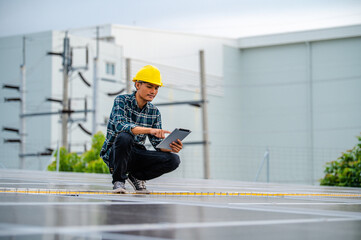 Asian engineer solar cell factory working with safety helmet outdoor