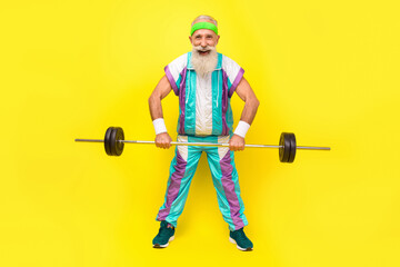 Poster - Full size portrait of handsome positive sporty granddad hold barbell wear condensed milk tin color sport suit isolated on yellow background