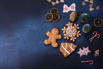 Christmas decorations and gingerbreads on a dark concrete table