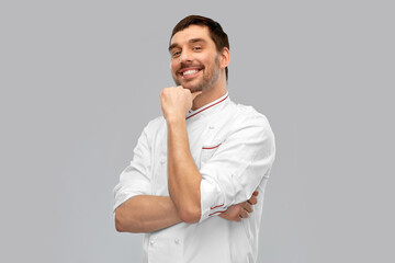 Wall Mural - cooking, culinary and people concept - happy smiling male chef in jacket over grey background