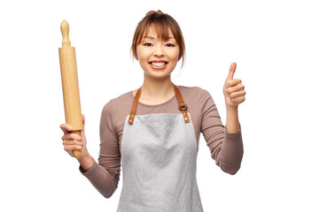 Sticker - cooking, culinary and people concept - happy smiling female chef in apron with wooden rolling pin showing thumbs up over white background