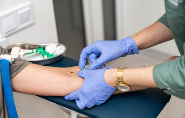 Blood taking for test. Medical professional taking blood samples.