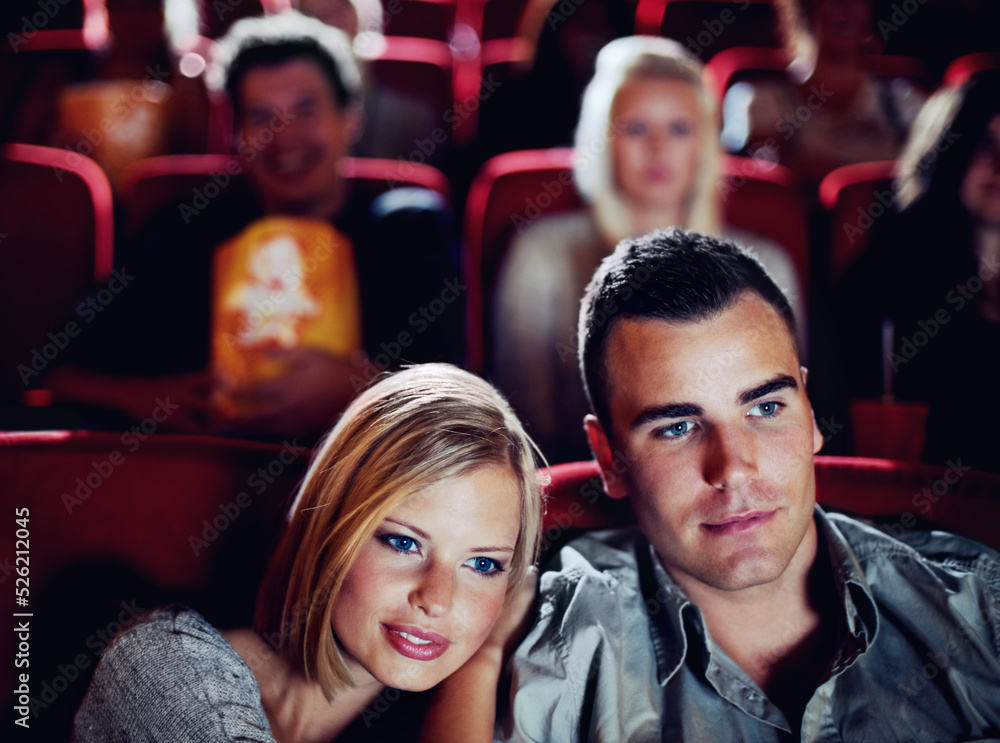 Love couple at cinema or movie theatre to watch entertainment film together at movie theater on a romantic date. Young happy people smile, romance and relationship at movies cinematography theater