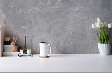 Wall Mural - Stylish workplace, home office desk with cup of coffee, flower pot and supplies on white table. Copy space for your text.