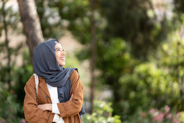 Portrait of a muslim woman looing to aside outdoors