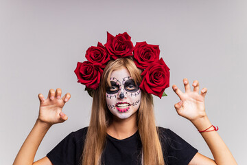 Portrait of teenager girl in a witch costume, on studio background. halloween make up