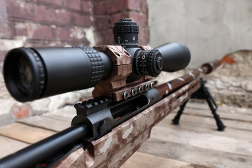 Closeup view of modern powerful sniper rifle with telescopic sight outdoors