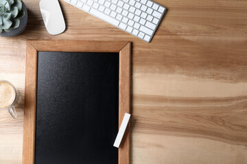 Sticker - Clean small blackboard, coffee and chalk on wooden table, flat lay. Space for text