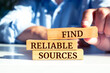 Wooden blocks with words 'Find reliable sources'. Business concept