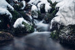 © Fauren - Travensky waterfall in the Visalaje area in the Beskydy mountains, eastern Czech Republic in a protected area. The water breaks through a layer of snow and fallen logs. Cleanliness and purity