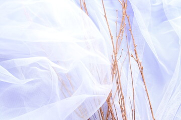 Wall Mural - dry bronze branches on white tulle with violet paper background and free space