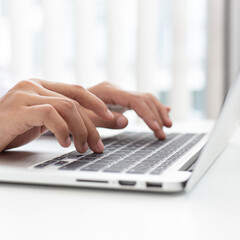 Wall Mural - Doctor uses a laptop computer to record patient information and write it on a document to prepare for diagnosis in the room of a modern hospital, Emergency assistance and health care concept.