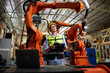 © offsuperphoto - factory worker or engineer operating remote switch controller to control robot machine in the factory