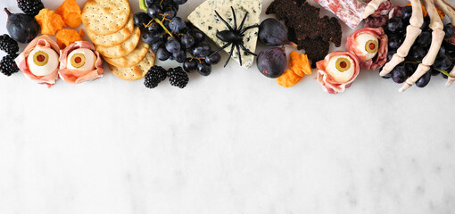 Canvas Print - Halloween theme charcuterie top border against a white marble background. Collection of cheeses and meat appetizers. Copy space.