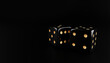 concept of gamble two black dice and gold dot on black casino background
