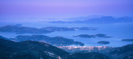Wall Mural - mountains, islands and city on the sea cost at night