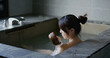 © leungchopan - Woman enjoy her hot spring at winter time