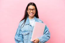 Young Student Colombian Woman Isolated On Pink Background Posing With Arms At Hip And Smiling