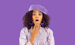 © Studio Romantic - Portrait of stunned teen African American girl isolated on purple studio background feel shocked by unexpected news. Amazed teenage biracial shocked by amazing sale deal or promotion.