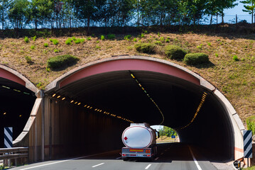 Wall Mural - Fuel tanker truck entering a highway tunnel,rear view.