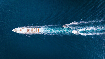 Wall Mural - an aerial view of the yacht on the blue sea. transparent clear water in the sea. summer vacations an