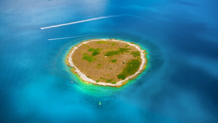 Wall Mural - an aerial view of an island in the middle of the blue sea. a seascape in the summertime. travelling 