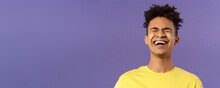 Close-up Portrait Of Happy Carefree Young Guy Laughing Loud, Chuckling Over Hilarious Joke, Bending Backwards And Close Eyes While Giggle Over Funny Movie, Purple Background