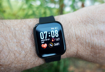 Man using fitness watch while out on hike