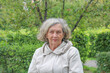© Darya - An elderly woman with gray hair is warmly dressed in cool weather. Retirement age