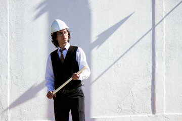 Elegant young engineer - architect working with his blueprints in hand while supervising a construction site in Venezuela