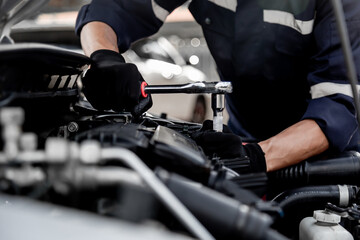 Car care maintenance and servicing, Close-up hand technician auto mechanic using the wrench to repairing change spare part car engine problem and insurance service support.