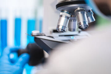 biotechnology scientist using scientific microscope for research in biology medicine laboratory, equ