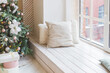 warm cozy beautiful modern design of the room in delicate light colors decorated with Christmas tree and decorative elements. Stylish Christmas interior decorated in pastel colors. Comfort home.