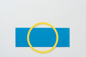 Poster - yellow paper ring isolated on a blue paper stripe