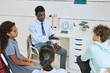 © Seventyfour - High angle view of male therapist leading support group session for teenage children