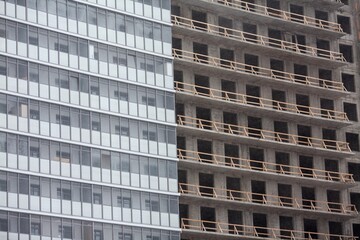 Construction of a multi-storey apartment building. Wall of a house under construction, half built, the second half not finished