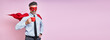 Leinwandbild Motiv Cheerful man in shirt and tie wearing superhero cape and holding coffee cup against pink background