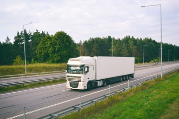 Truck with container on highway, cargo transportation concept.