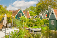 Dutch Country Houses And A Pond With A Boat