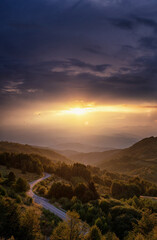 Wall Mural - Beautiful summer mountain landscape, clouds and sun rays at sunset. Vertical shot