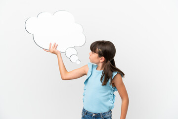 Wall Mural - Little caucasian kid isolated on white background holding a thinking speech bubble