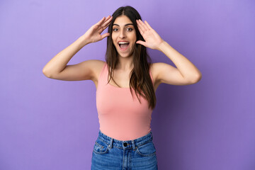 Young caucasian woman isolated on purple background with surprise expression