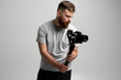 © Volodymyr - Professional content creator with a dslr camera on 3-axis gimbal stabilizer. Filmmaking, videography, hobby and creativity concept.