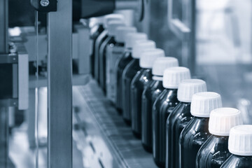 Poster - pharmaceutical industry, medicine pills are filling in the  bottle on production line machine conveyor at the medical factory. selective focus.