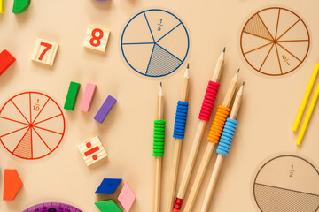 Wall Mural - Wooden toy blocks. School supplies, math fractions, pencils, numbers, on beige background. Back to school, education concept background