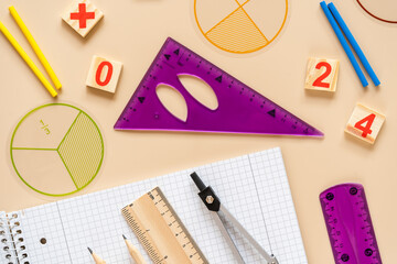 Wall Mural - Wooden toy blocks. School supplies, math fractions, pencils, numbers, on beige background. Back to school, education concept background	
