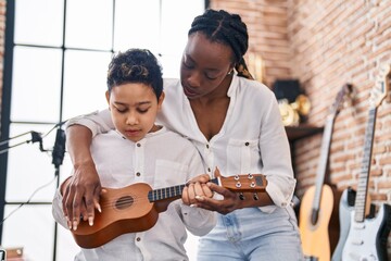 Poster - African american mother and son student learning play ukelele at music studio