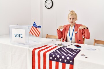 Poster - Beautiful caucasian woman working at political campaign pointing down looking sad and upset, indicating direction with fingers, unhappy and depressed.