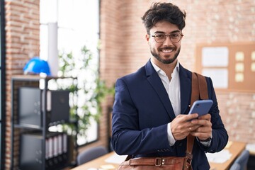 Poster - Young hispanic man business worker using smartphone at office